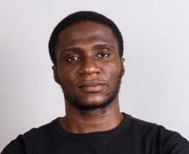 studio shot of young african man against gray background horizontal shot